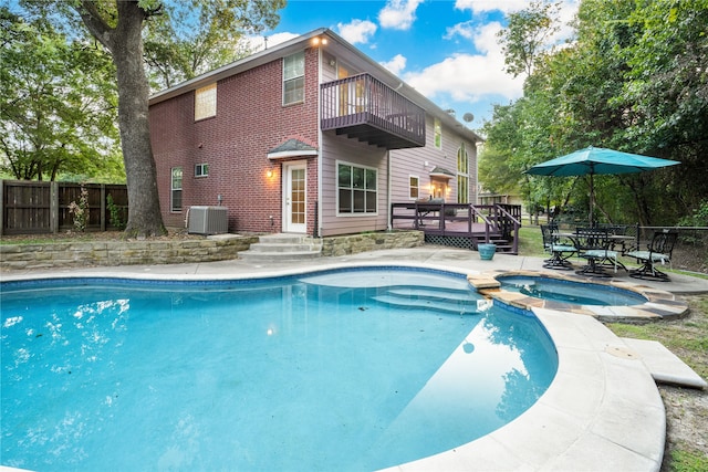 view of pool featuring an in ground hot tub and central AC unit