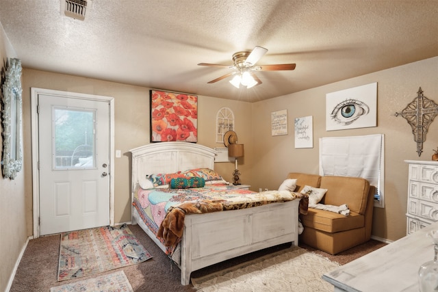 bedroom with a textured ceiling, ceiling fan, and carpet