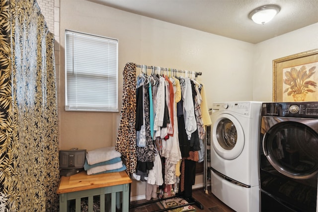 laundry room featuring dark wood-type flooring, a textured ceiling, and washer and dryer