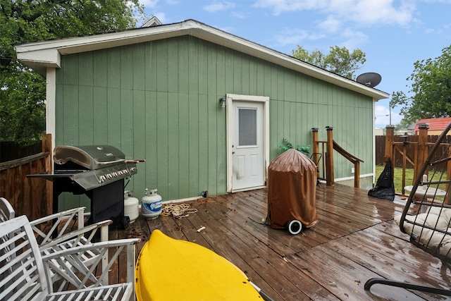 wooden terrace featuring a grill