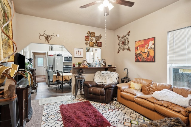 living room featuring a wealth of natural light, ceiling fan, and light hardwood / wood-style floors