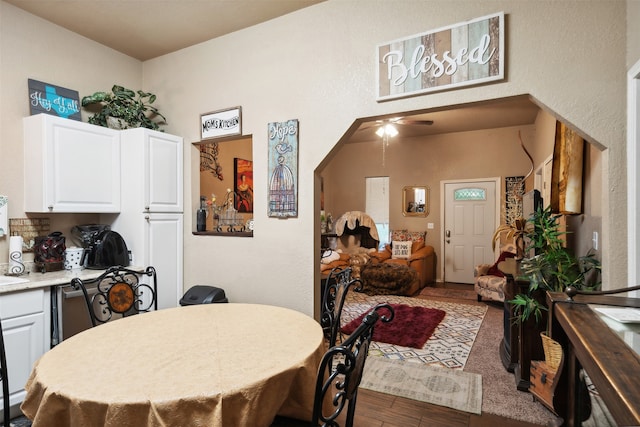 dining room with ceiling fan and dark hardwood / wood-style floors