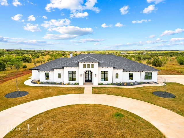 view of front of home featuring a front lawn and french doors