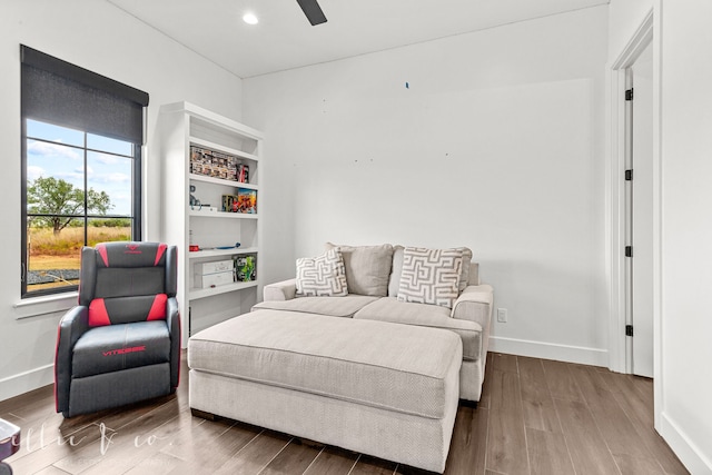 sitting room with hardwood / wood-style floors and ceiling fan