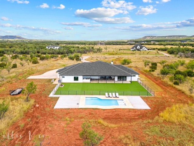 view of pool with a lawn, a mountain view, and a patio