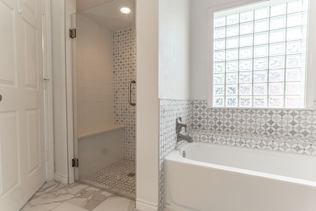 bathroom with separate shower and tub