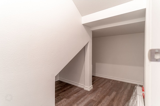 stairs featuring hardwood / wood-style floors and vaulted ceiling