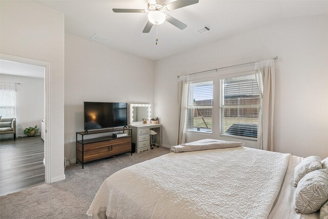 bedroom with vaulted ceiling, ceiling fan, and light hardwood / wood-style floors