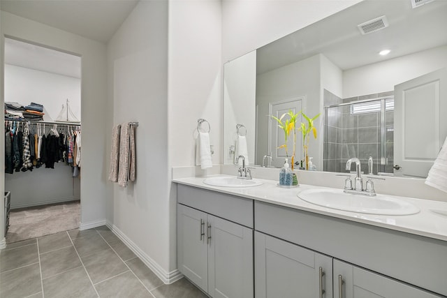 bathroom with tile patterned flooring, vanity, and an enclosed shower