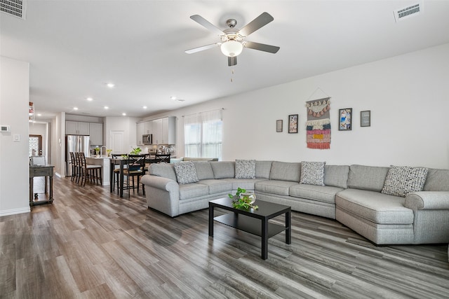 living room featuring ceiling fan and wood-type flooring