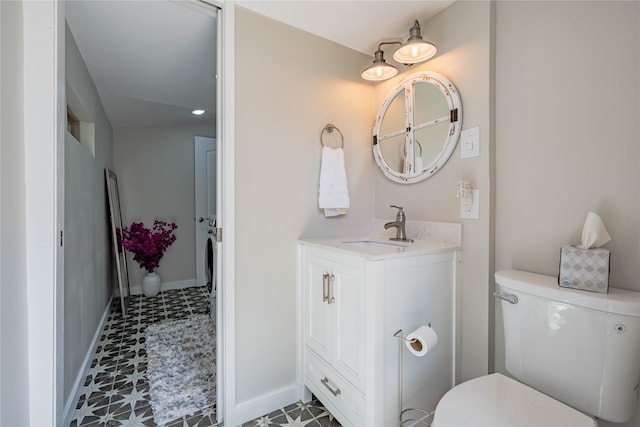 bathroom with vanity, toilet, and tile patterned flooring