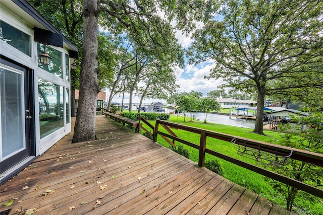 deck featuring a lawn and a water view