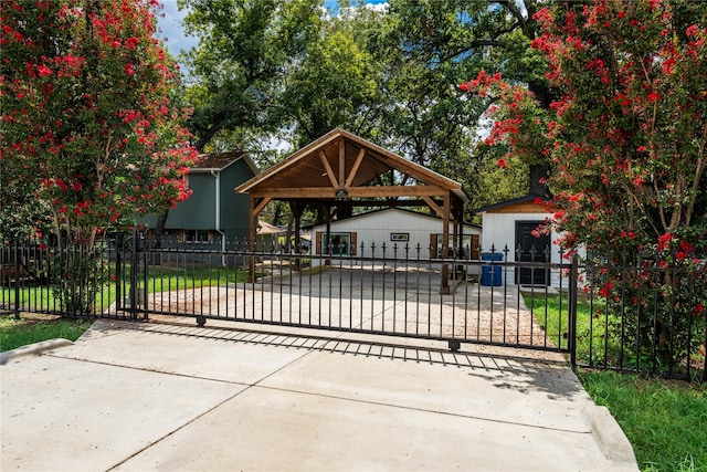 view of gate featuring an outbuilding