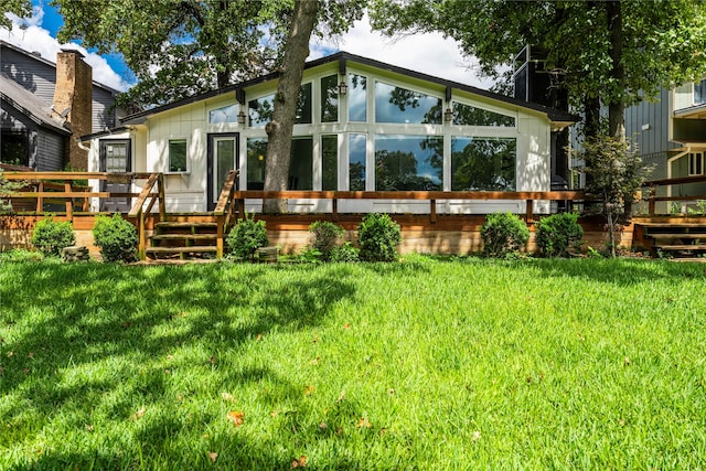 back of house with a lawn and a wooden deck