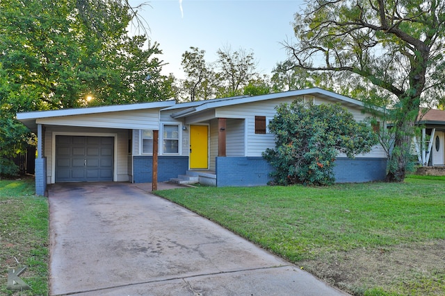 single story home with a front yard and a garage