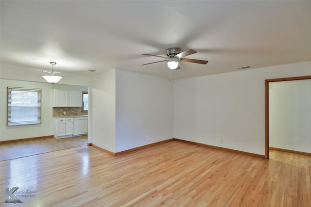 spare room with light wood-type flooring and ceiling fan