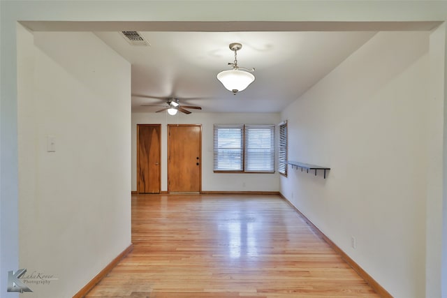 empty room featuring ceiling fan and light hardwood / wood-style flooring