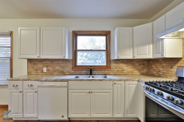 kitchen featuring white cabinets, backsplash, stainless steel gas range oven, white dishwasher, and sink