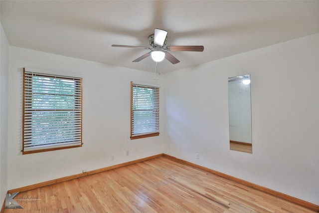 empty room featuring ceiling fan, plenty of natural light, and light hardwood / wood-style floors