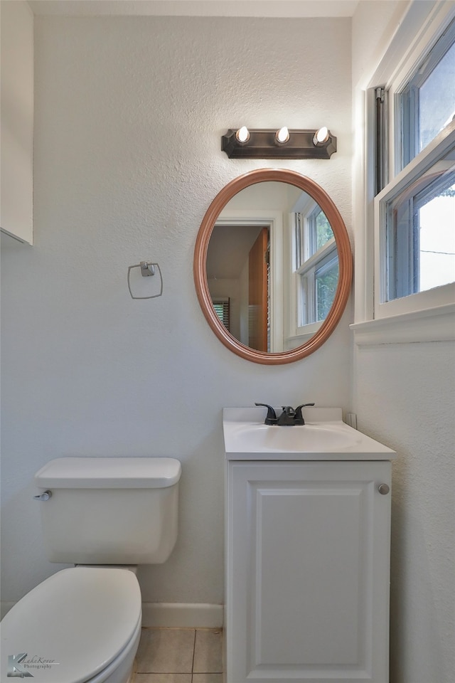 bathroom featuring vanity, tile patterned flooring, and toilet