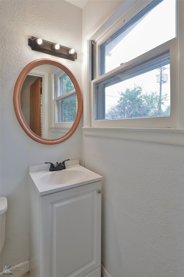 bathroom featuring vanity and toilet