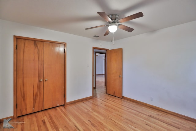 unfurnished bedroom featuring ceiling fan, a closet, and light hardwood / wood-style floors