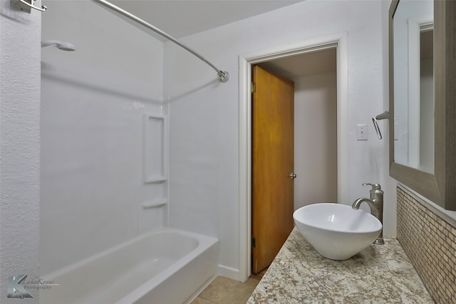 bathroom with shower / bathtub combination, tile patterned floors, and sink