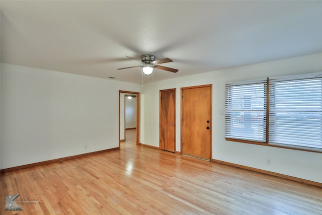 spare room featuring ceiling fan and light hardwood / wood-style flooring