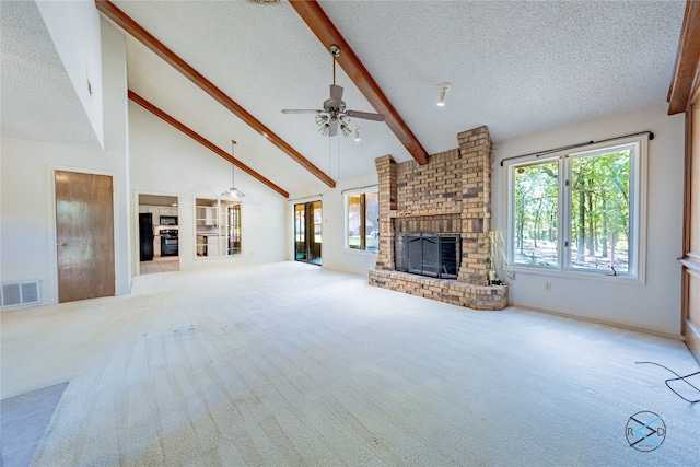 unfurnished living room featuring a fireplace, light colored carpet, ceiling fan, high vaulted ceiling, and a textured ceiling