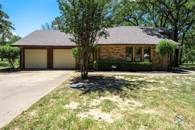 ranch-style house featuring a garage and a front yard