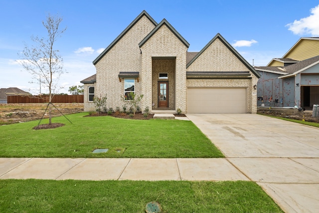 view of front of property with a front lawn and a garage