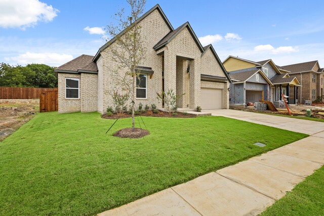 view of front of house featuring a front yard and a garage