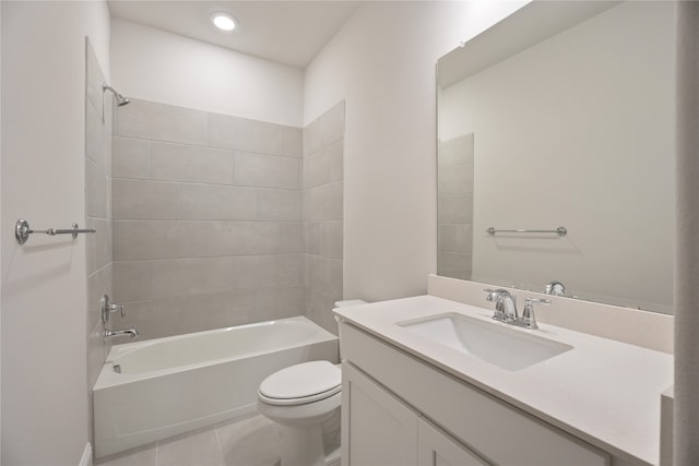 full bathroom featuring tile patterned floors, tiled shower / bath combo, vanity, and toilet