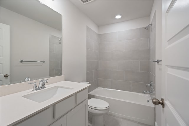 full bathroom with toilet, vanity, tiled shower / bath combo, and tile patterned flooring