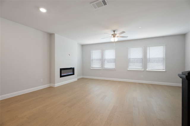 unfurnished living room with light hardwood / wood-style floors and ceiling fan