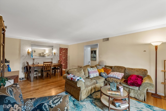 living room featuring ornamental molding and hardwood / wood-style floors