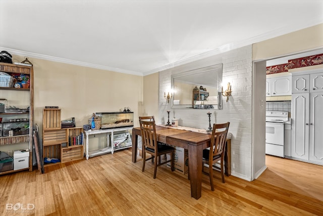 dining space featuring light hardwood / wood-style floors and ornamental molding