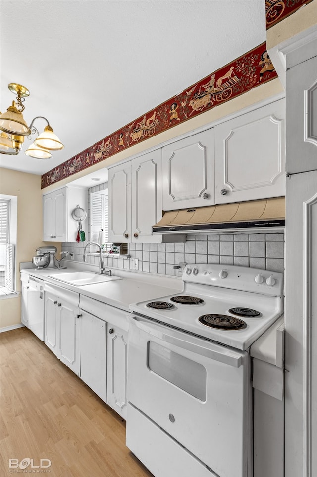 kitchen with white appliances, sink, white cabinets, and tasteful backsplash