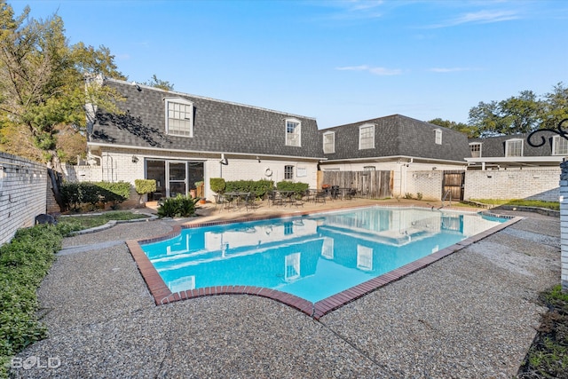 view of swimming pool with a patio area