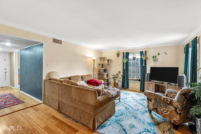 living room featuring ornamental molding and wood-type flooring