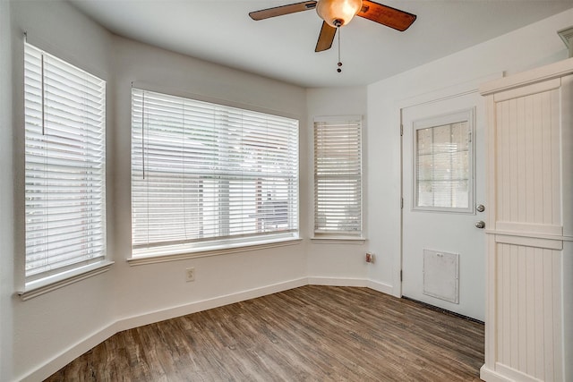 unfurnished room with hardwood / wood-style floors, ceiling fan, and a healthy amount of sunlight