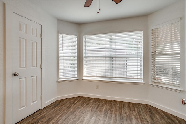 spare room with dark wood-type flooring and ceiling fan