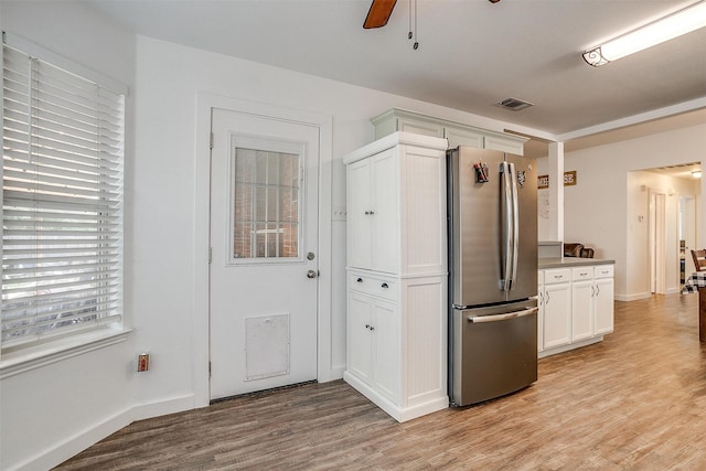 kitchen featuring plenty of natural light, ceiling fan, stainless steel refrigerator, and light hardwood / wood-style floors