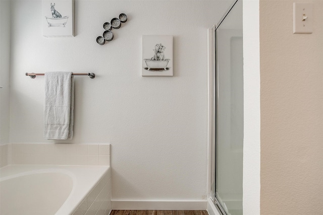 bathroom with plus walk in shower and hardwood / wood-style floors