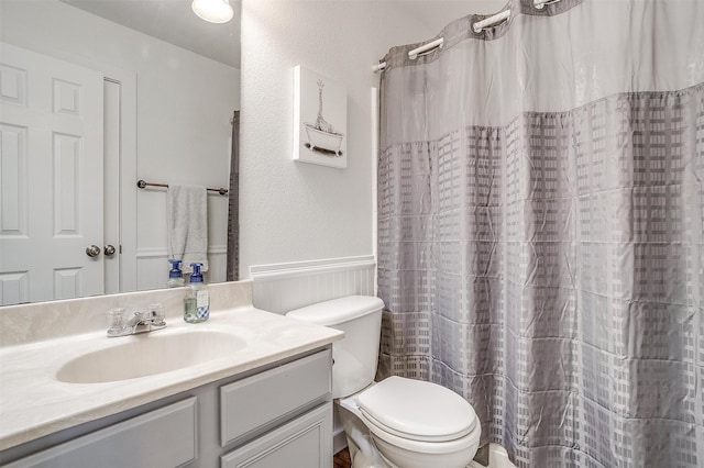 bathroom featuring vanity, toilet, a shower with curtain, and wood walls