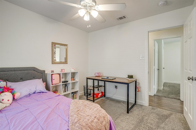 bedroom with ceiling fan and light hardwood / wood-style flooring