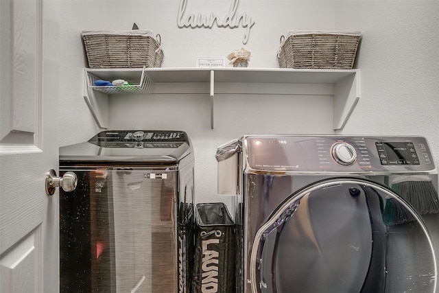 laundry area featuring washing machine and clothes dryer