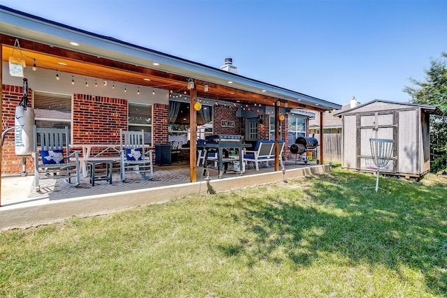 back of house with a storage shed, a yard, and a patio area