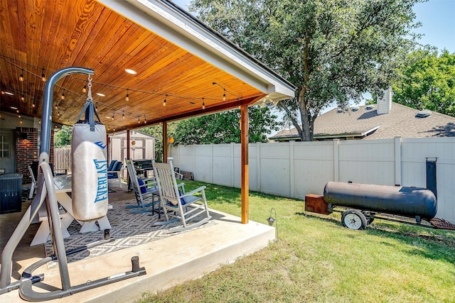 view of yard featuring a shed and a patio area