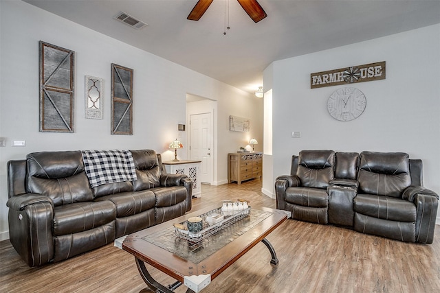 living room with ceiling fan and light hardwood / wood-style floors